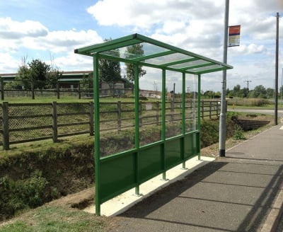 Cantilever bus shelter with steel frame and polycarbonate panels.