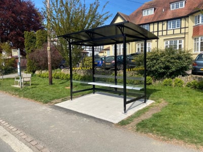 Jewel bus shelter with steel frame and polycarbonate panels, seating and an advertising case