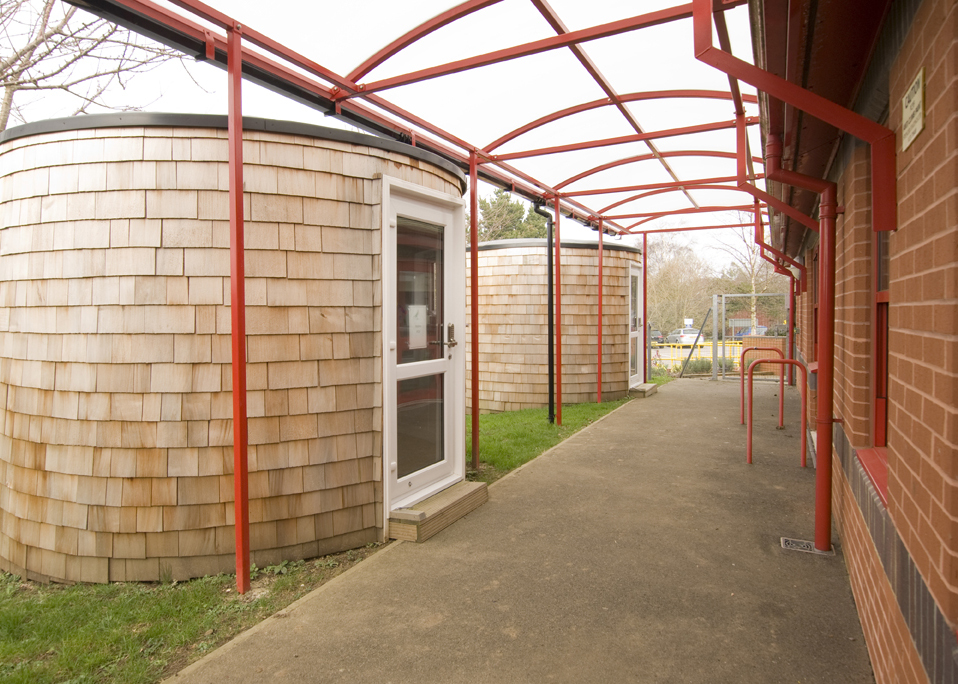 Image of a black shelter store walkway canopy installed at a school