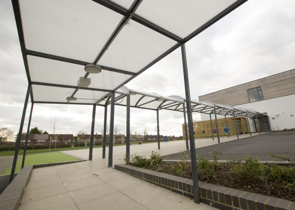 Image of a red shelter store walkway canopy installed at a school
